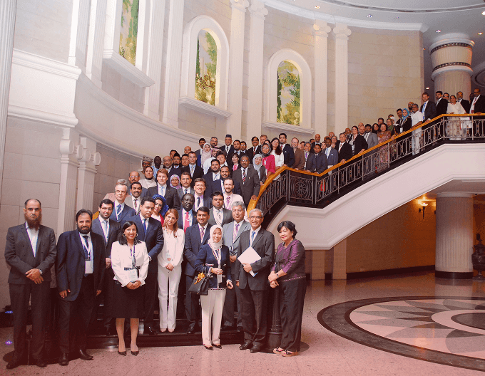 Image of attendees in front of a staircase for a photo